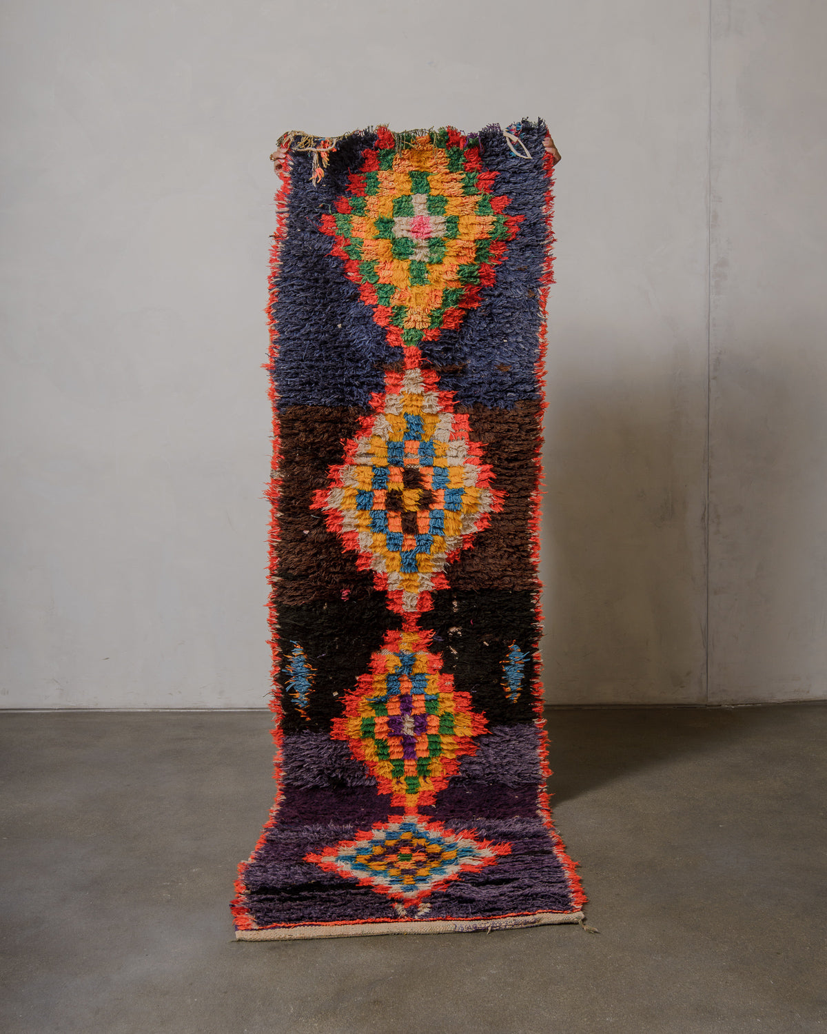Colorful geometric-patterned rug on a plain background